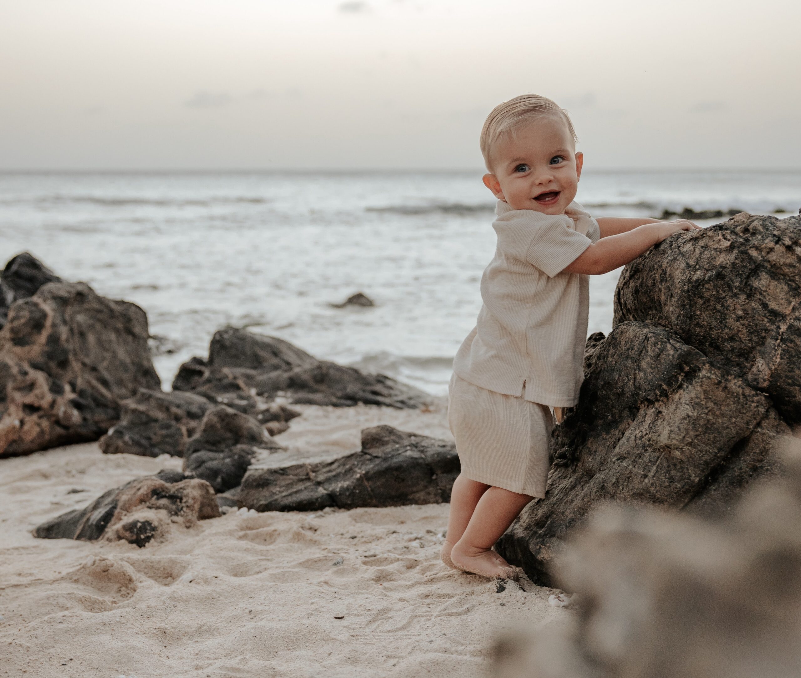 Baby on the beach and rocks Aruba